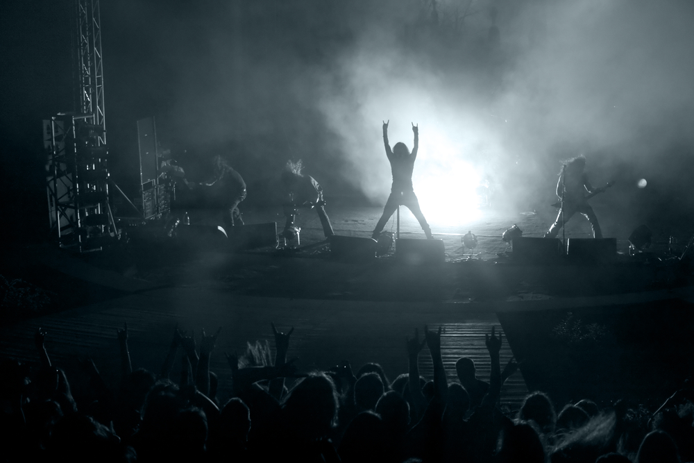 Concert: silhouette of rock singer in front of ecstatic crowd